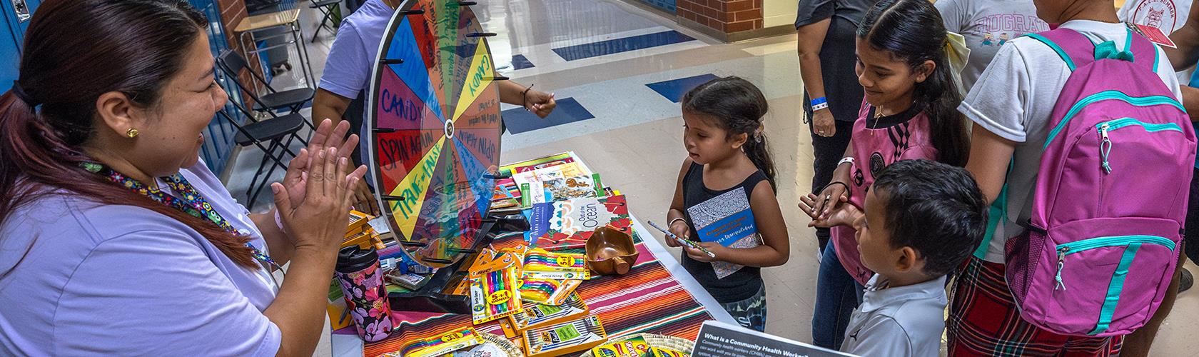 kids spin the prize wheel at the our bridge for kids table at the ELFAS community event