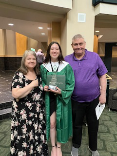 Alyssa Peterson with family at her HS graduation.