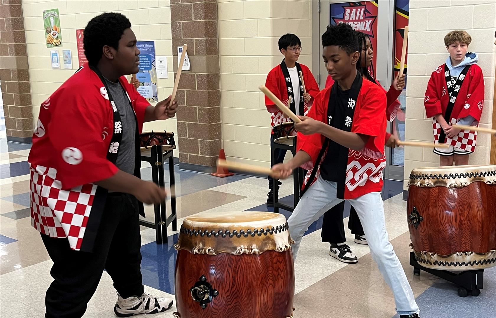  Students playing playing taiko drums