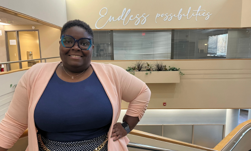  Shaniqua Berry stands on the staircase in the Elizabeth Schmoke Randolph building.