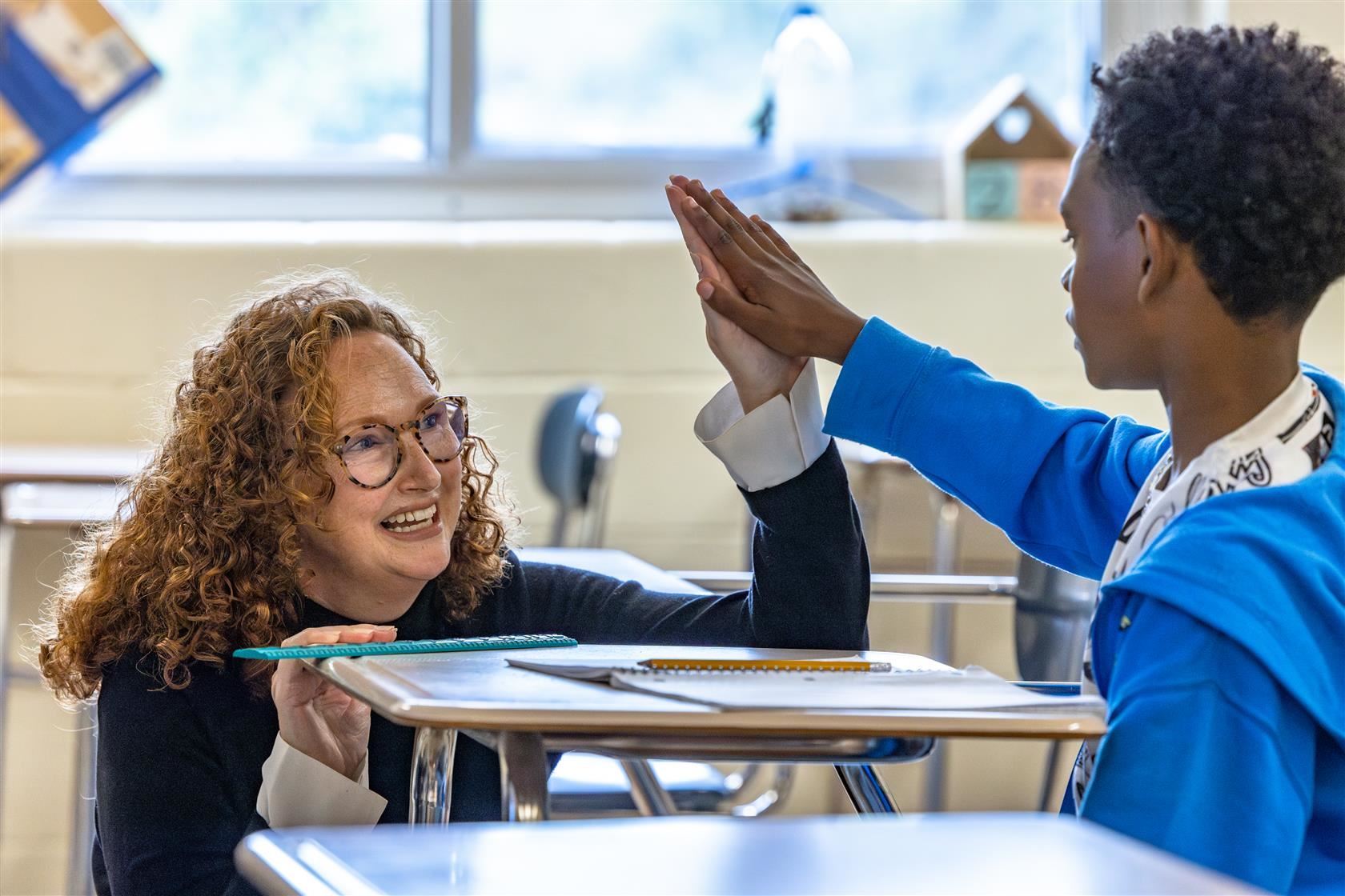 Coulwood STEM principal high fives a student