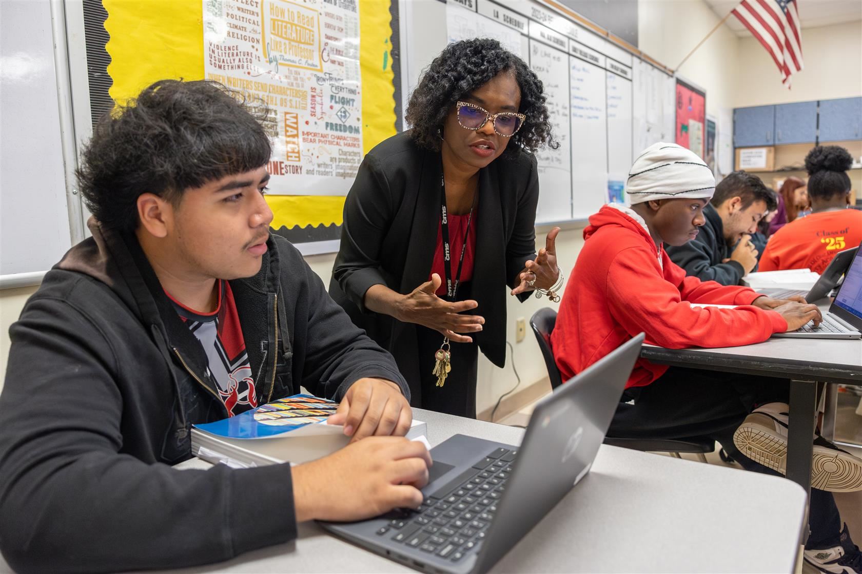 POB Principal Tanya Branham talks with student at a desk