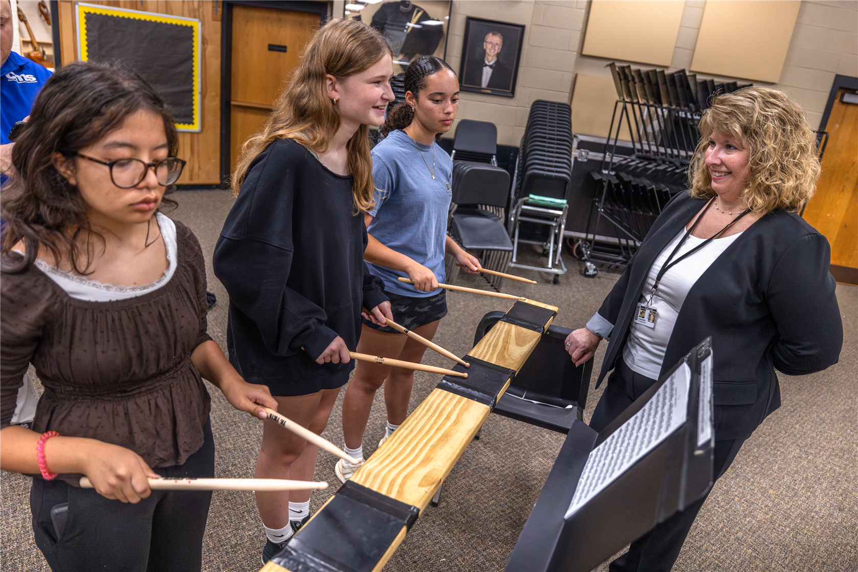 Dr. Harrill watching students play instruments