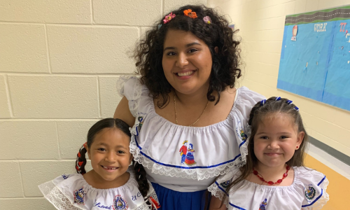  Reyes with two of her students