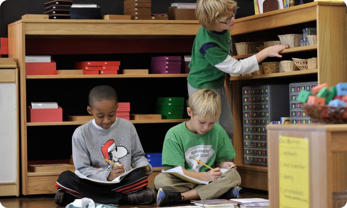 Students in classroom writing in their notebooks.