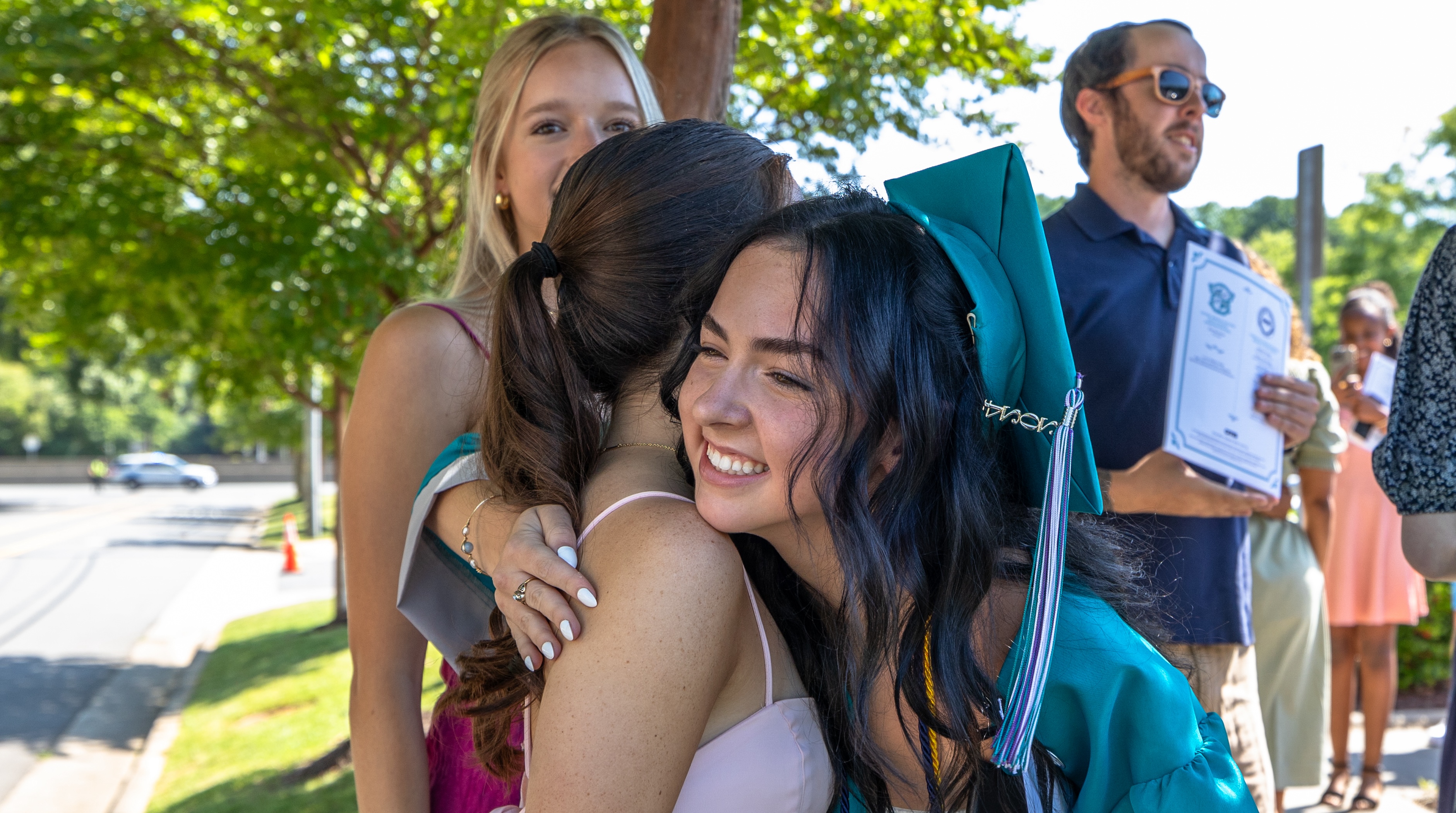 High School Graduate hugging family member