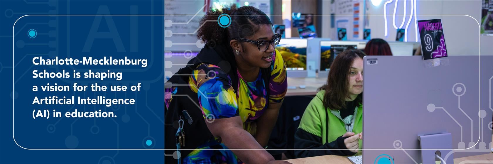 Teacher assisting student on the computer.