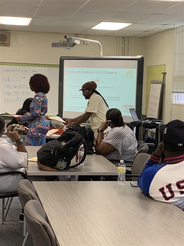 Ms. Hamilton (Discipline Technician) and Mr. Shalom (District Lead BMT) present on the Power of Relationships Between Students and BMTs during a workday training.
