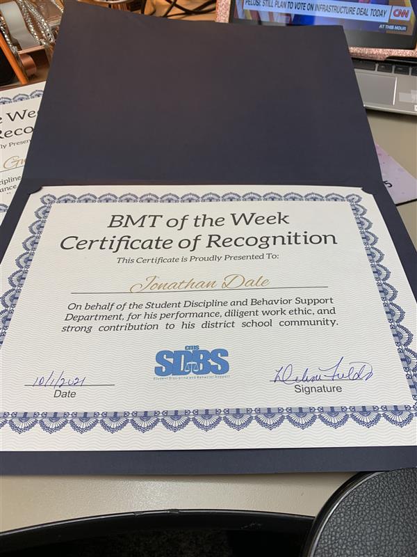 Celebrating our BMT staff with a certificate of recognition and a gift card.